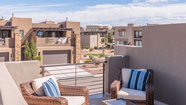 A rooftop terrace with wicker furniture and a clear view of neighboring buildings. - Serene 3BR w/ Private Hot Tub - Snow Canyon Views (Saint George)
