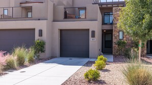 A modern two-story house with a garage, a balcony, and a well-maintained garden. - Serene 3BR w/ Private Hot Tub - Snow Canyon Views (Saint George)