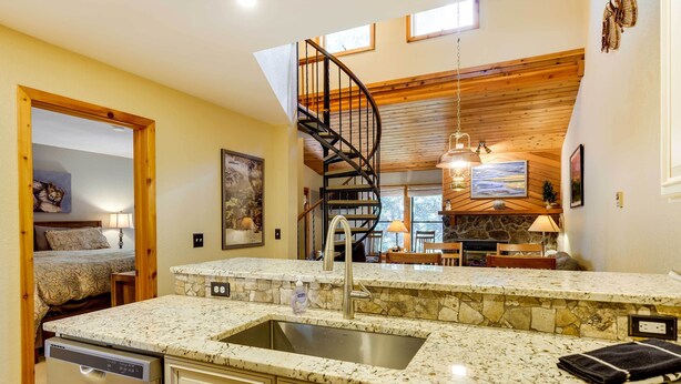 A kitchen with granite countertops, a built-in dishwasher, and a stone backsplash. - Winter Park Condo w/ Sleeping Loft - Near Main St (Winter Park)