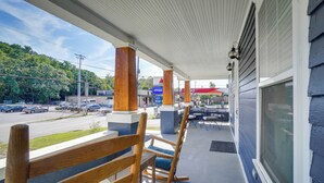 A porch with wooden rocking chairs, a gas station in the background, and a clear view of the street. - '1001 Sevier Bungalow': 2 Mi to Neyland Stadium! (Knoxville)