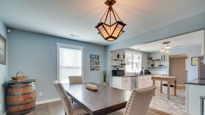 A dining area with a wooden table, chairs, and a hanging light fixture. - '1001 Sevier Bungalow': 2 Mi to Neyland Stadium! (Knoxville)
