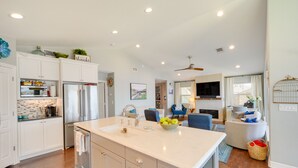 A modern kitchen with white cabinets, a large island, and a built-in oven. - Beautiful Marble Falls Getaway on Lake Lbj! (Marble Falls)