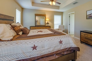 A bedroom with a bed, a dresser, a chair, a mirror, and a ceiling fan. - Pleasanton Vacation Rental w/ Private Yard! (Pleasanton)