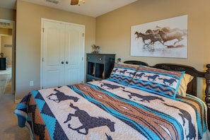 A bedroom with a bed, a wardrobe, and a painting on the wall. - Pleasanton Vacation Rental w/ Private Yard! (Pleasanton)