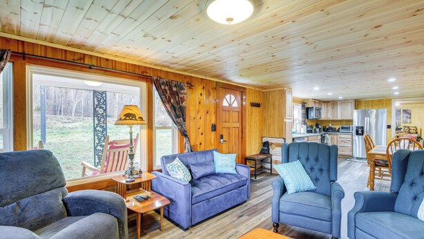 A cozy cabin interior with a living room, dining area, and kitchen. - Fire Pit & Covered Deck! Cozy, Rustic Cosby Cabin (Cosby)