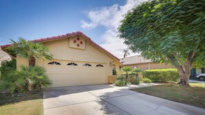 A residential house with a garage, palm trees, and a clear sky. - Resort Perks, Patio & Gas Grill: Indio Retreat! (Indio)