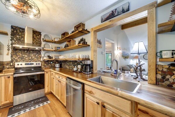 Enjoy cooking in this well-equipped kitchen with a stainless steel stove, dishwasher, and large sink.