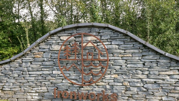A stone wall with a metal sign that reads "Ironworks". - Watch Tree Apartment (Ulverston)