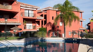 A swimming pool with a geometric tile pattern, surrounded by a fence. - Spacious condo with Sea View, Walking distance to the Beach, Pool, Parking, Wifi (manilva)