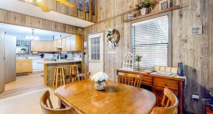 Delightful creekside cabin w/ spacious deck, private hot tub, fire pit, & views