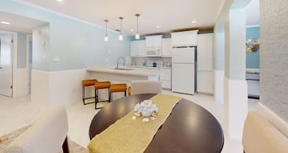Waterfront condo with an outdoor pool, washer/dryer, & central AC