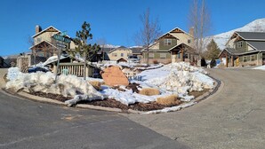 A residential area with houses, a snow-covered landscape, and a sign indicating 'Fairview Loop'. - Basin Lakeside Getaway MH702|Near Powder Mtn |Hot Tub (Eden)