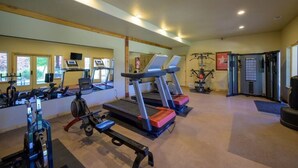 A gym with treadmills, weight machines, and a mirrored wall. - Basin Lakeside Getaway MH702|Near Powder Mtn |Hot Tub (Eden)
