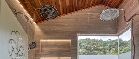 A modern shower area with wooden ceiling and walls, a window with a view, and a decorative wall piece.