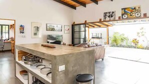 A modern kitchen with a central island, open shelving, and a view to the outdoors. - Casa Tranquila, Brand NEW Modern Villa with Pool (Sámara)