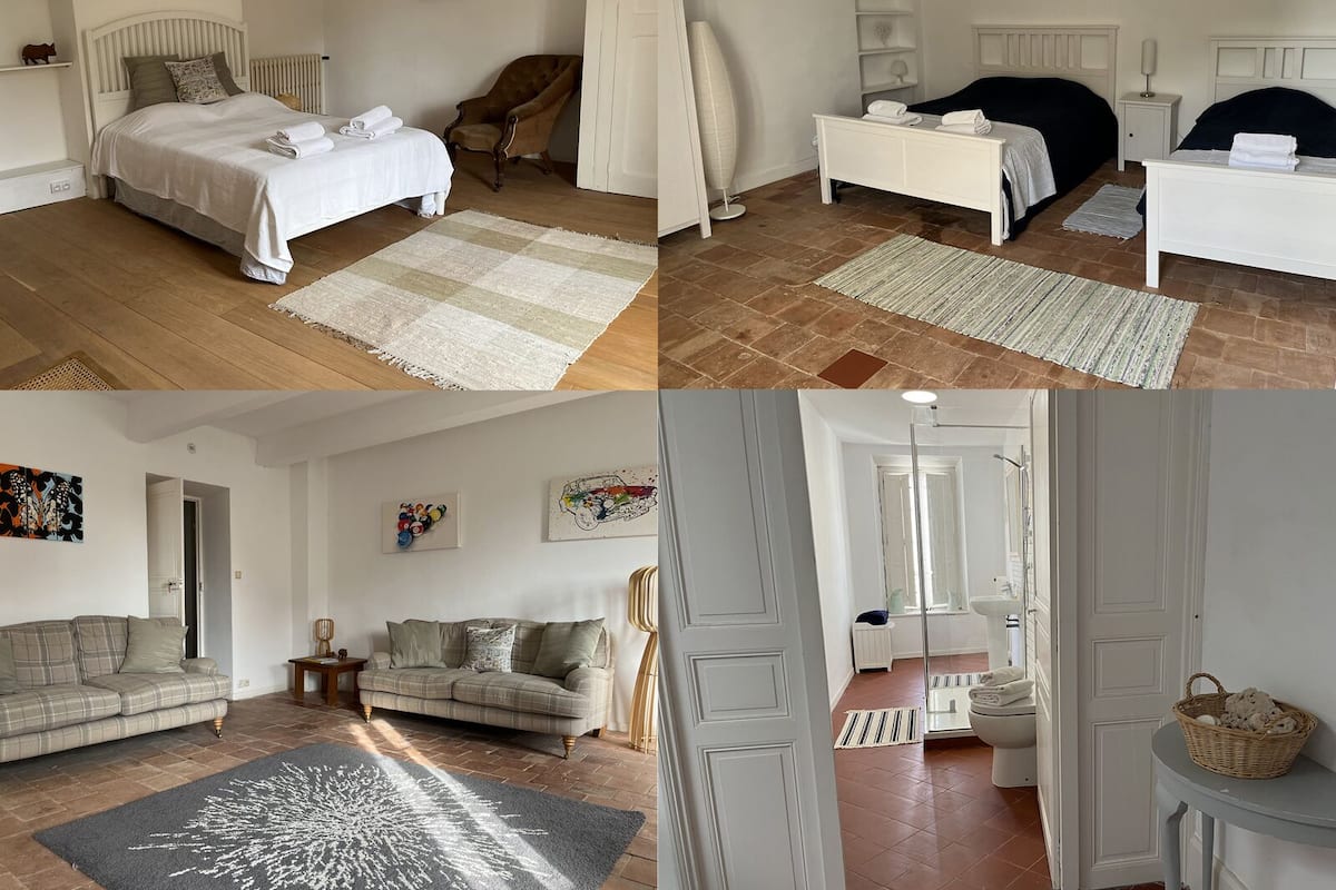 A hotel room with a bed, a chair, a bedside table, a wardrobe, and a bathroom.