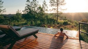 A wooden deck with a hot tub and lounge chairs overlooking a forested area. - Reserva Natural Iguazú - Pristine Luxury Camp (Puerto Libertad)