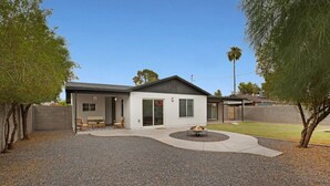 A single-story house with a covered patio, a fire pit, and a small lawn area. - Newly Renovated Home, 1 mi Downtown - 3 BR 2 Bath (Chandler)