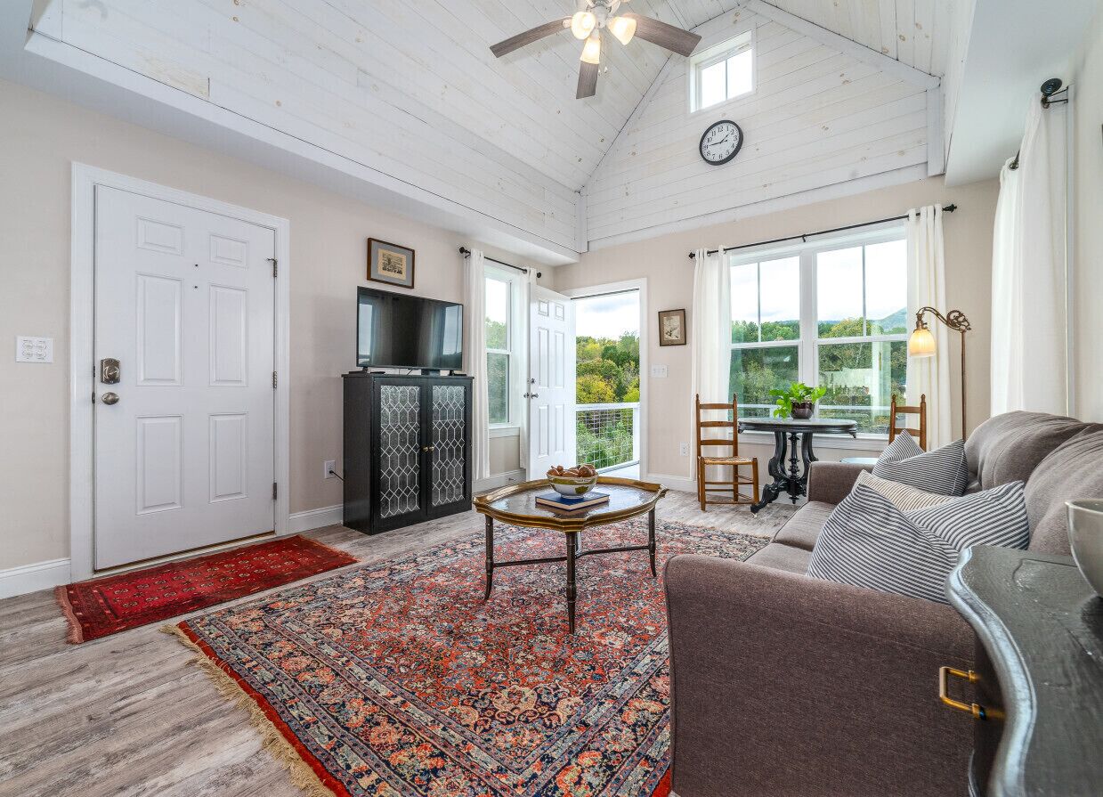 Comfortable living room with great lighting and a flat-screen TV for your entertainment.