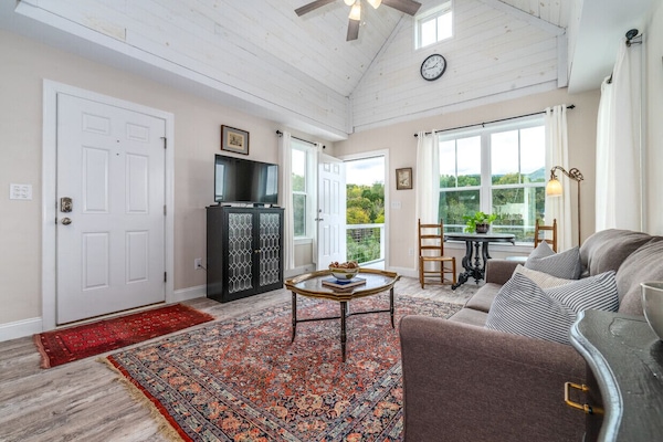 Comfortable living room with great lighting and a flat-screen TV for your entertainment.