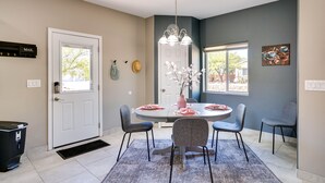 A dining area with a round table, four chairs, a chandelier, and a door labeled "MAIL". - Tucson Vacation Rental w/ Community Pool! (Tucson)