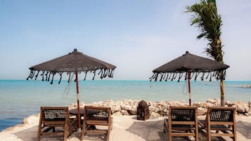 Beach nearby, white sand, sun loungers, beach towels