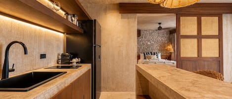 A modern kitchen with a built-in island, stainless steel appliances, and a hanging light fixture.