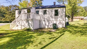 A two-story white house with a front porch and a small front yard. - Charming Greensboro Home - 2 Mi to Downtown! (Greensboro)