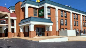 A multi-story building with a prominent 'HomeTown Studios' sign. - HomeTowne Studios by Red Roof Prattville (Prattville)