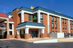 A multi-story building with a green sign reading "Home Towne Studios."