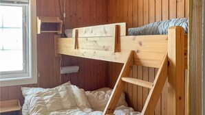 A bunk bed with a wooden ladder, a window, and a white wall. - 3 bedroom lovely home in Hemsedal (Hemsedal)