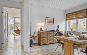 Enjoy meals in the spacious dining area with a wooden table and comfortable seating.