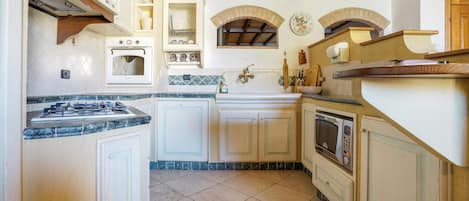 Fridge, stovetop, dishwasher, coffee/tea maker