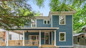 A two-story house with a porch and a small front yard.