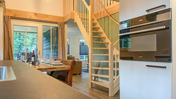 A modern kitchen with a built-in oven and a wooden staircase leading to an upper level. - Gorgeous home in Marienberg with WiFi (Marienberg)