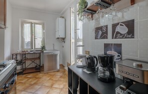 Fridge, stovetop, dishwasher, coffee/tea maker