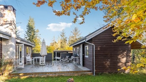A wooden cabin with a deck, outdoor seating, and a grill area. - Amazing home in Nykøbing Sj with WiFi (Nykøbing Sj)