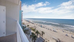 A balcony overlooking a beach with a clear sky. - 🌊Gulf Front Condo with Amazing Views-Ocean House 2604🌊 (Gulf Shores)