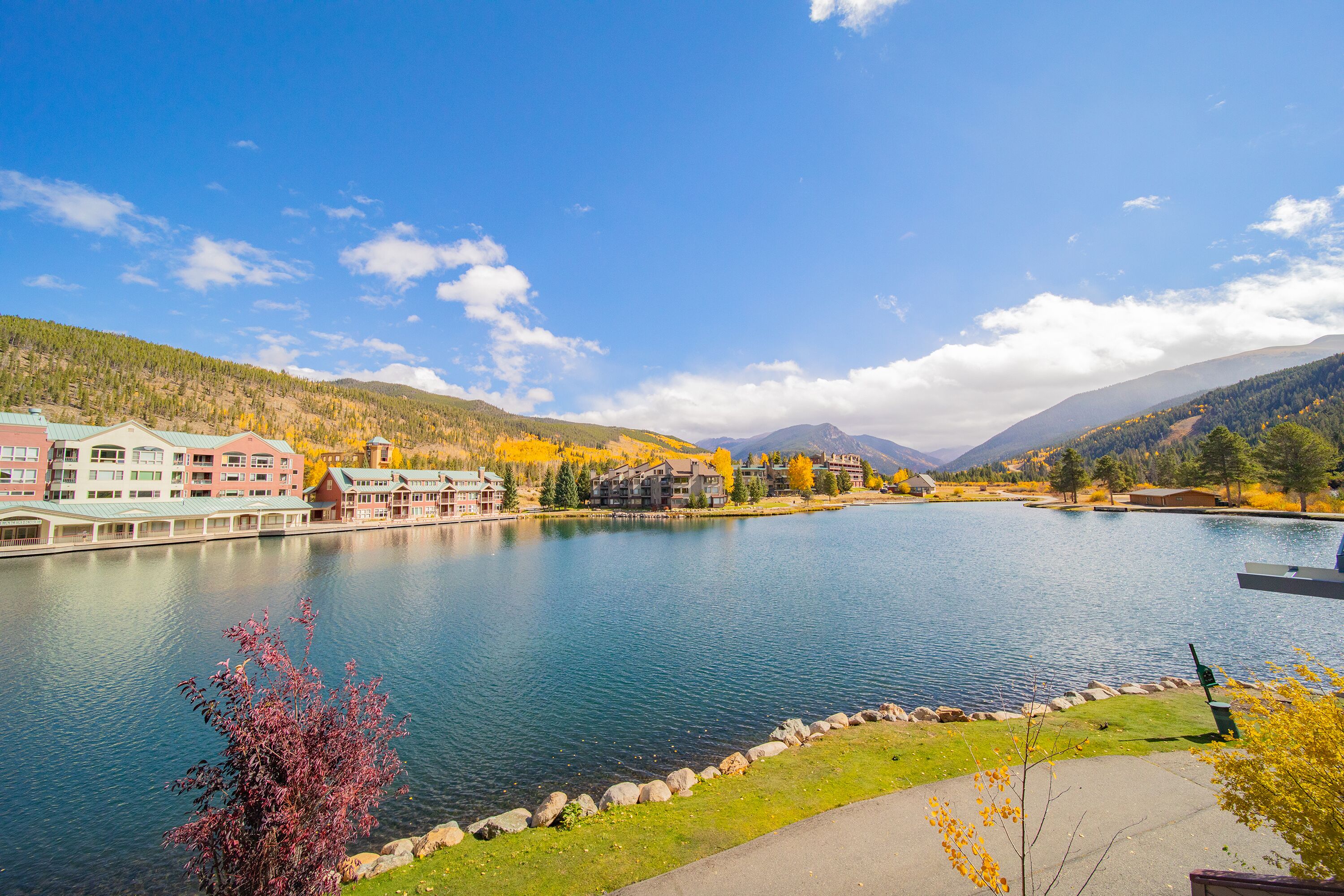 A lakeside hotel with a view of the lake and mountains.