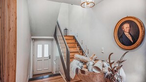 A staircase with wooden steps and a metal railing, leading to a white door. - 3 bedroom beautiful home in Wartenberg (Wartenberg)