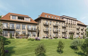 Ein großes, mehrstöckiges Gebäude mit Balkonen und einer Steinaußenfassade.