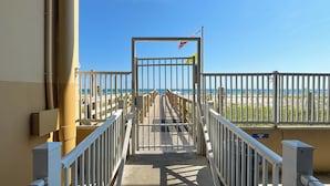 A gated entrance to a beach area with a clear view of the ocean. - Crystal Shores West 1402 | Beachfront Penthouse | Pools, Fitness, Sauna | Beach Getaways (Gulf Shores)