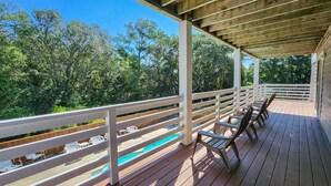 A wooden deck with white railings, a pool, and outdoor seating. - Fair Winds - Oceanside home w/Private Pool - Dogs Allowed! (Southern Shores)