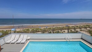 A pool area with a view of the beach and ocean. - Star Gazer - Wake up to an Outer Banks sunrise from this luxurious oceanfront home (Duck)