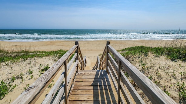 A wooden boardwalk leading to a beach with ocean views. - Carolina Dreamin' - Oceanfront 5 BR Home with community pool - Dogs Allowed (Duck)