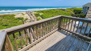 A wooden deck with a view of the ocean and beach. - Carolina Dreamin' - Oceanfront 5 BR Home with community pool - Dogs Allowed (Duck)