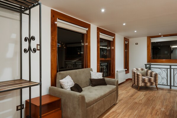 Relax in this inviting living room with a sofa, coffee table, and armchair.