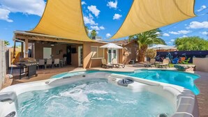 A backyard with a hot tub, a pool, and a covered patio area. - 4BR Scottsdale Tempe Oasis! Heated Pool & Hot Tub! (Tempe)