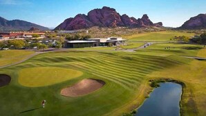 A golf course with bunkers, a pond, and mountains in the background. - 4BR Scottsdale Tempe Oasis! Heated Pool & Hot Tub! (Tempe)