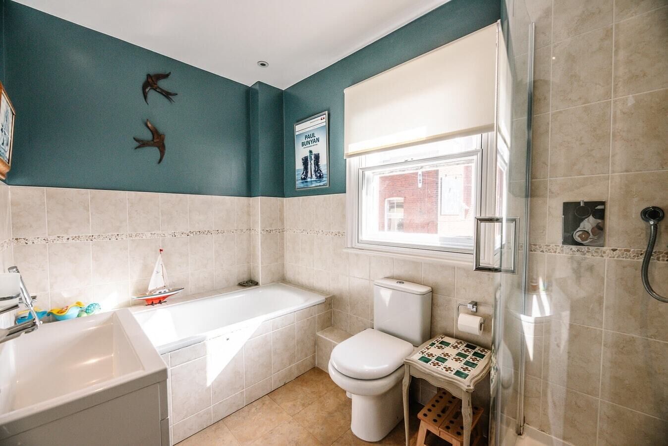 A bathroom with a bathtub, toilet, and shower.